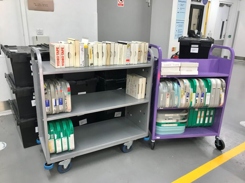 Image of video and LTO tapes on two library trolleys