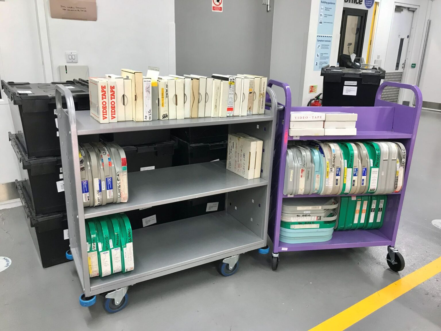 Image of video and LTO tapes on two library trolleys